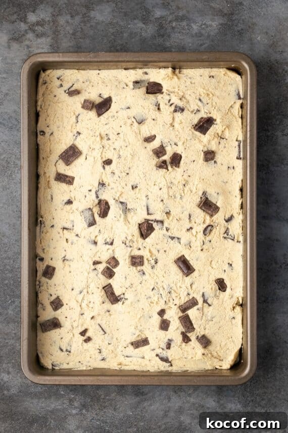 Fill the pan and bake! Chocolate chip cookie dough pressed into a rectangular baking pan.