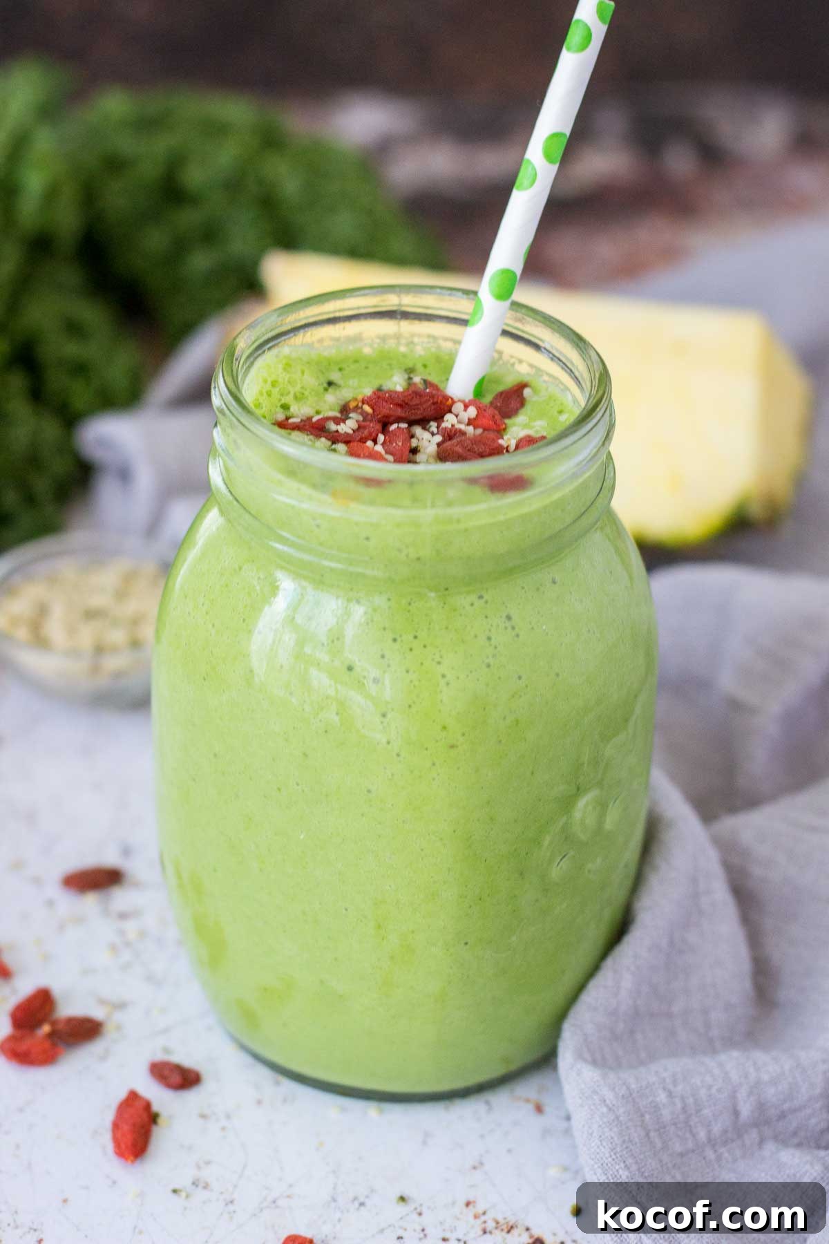 Kale and Pineapple Smoothie for Energy and Glow 6 Kale Pineapple Smoothie served in a glass with the straw