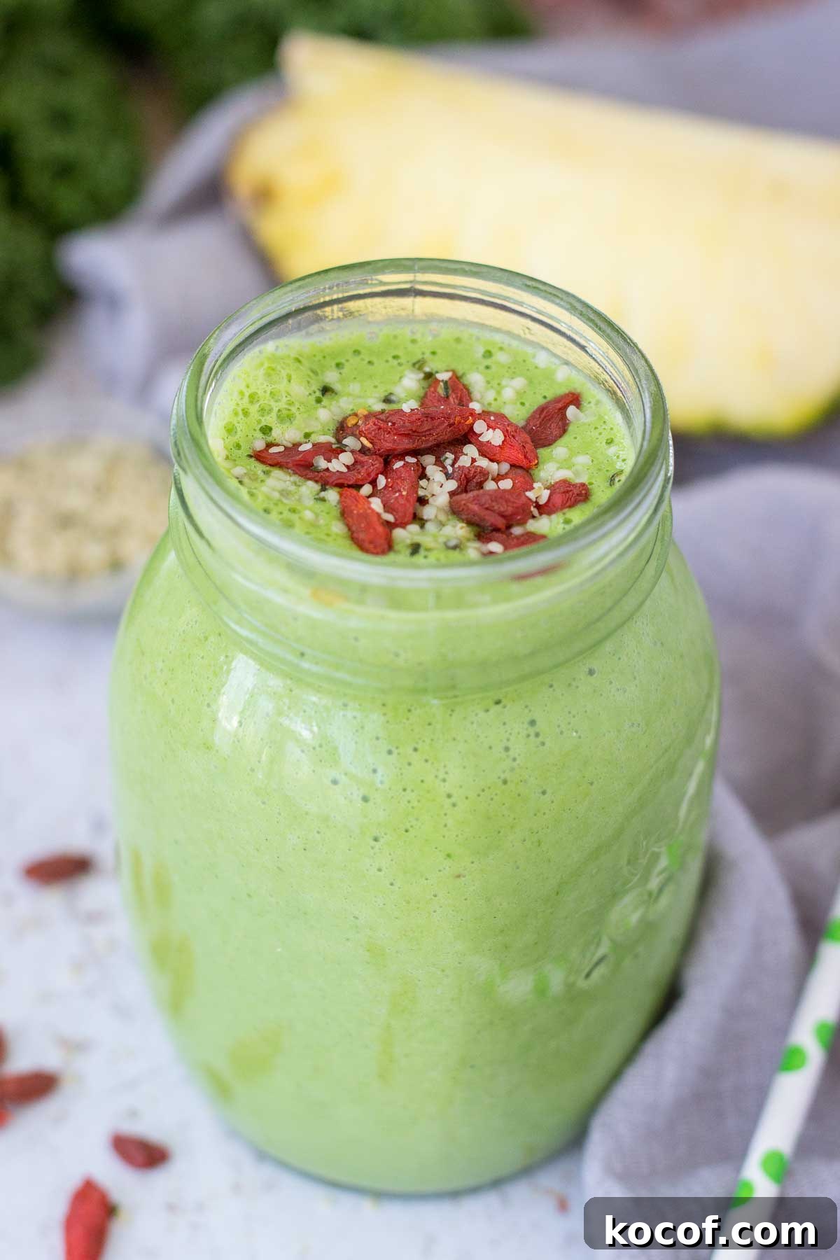 Kale and Pineapple Smoothie for Energy and Glow 7 Kale Pineapple Smoothie served in a glass topped with goji berries