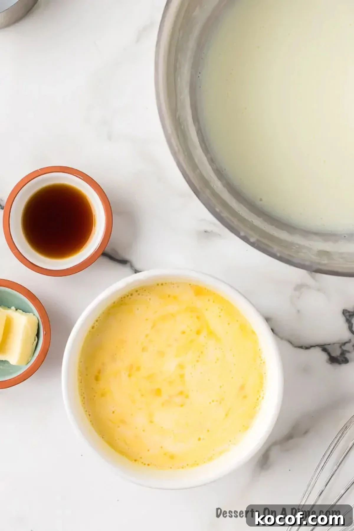 Milk added to eggs and combined. 