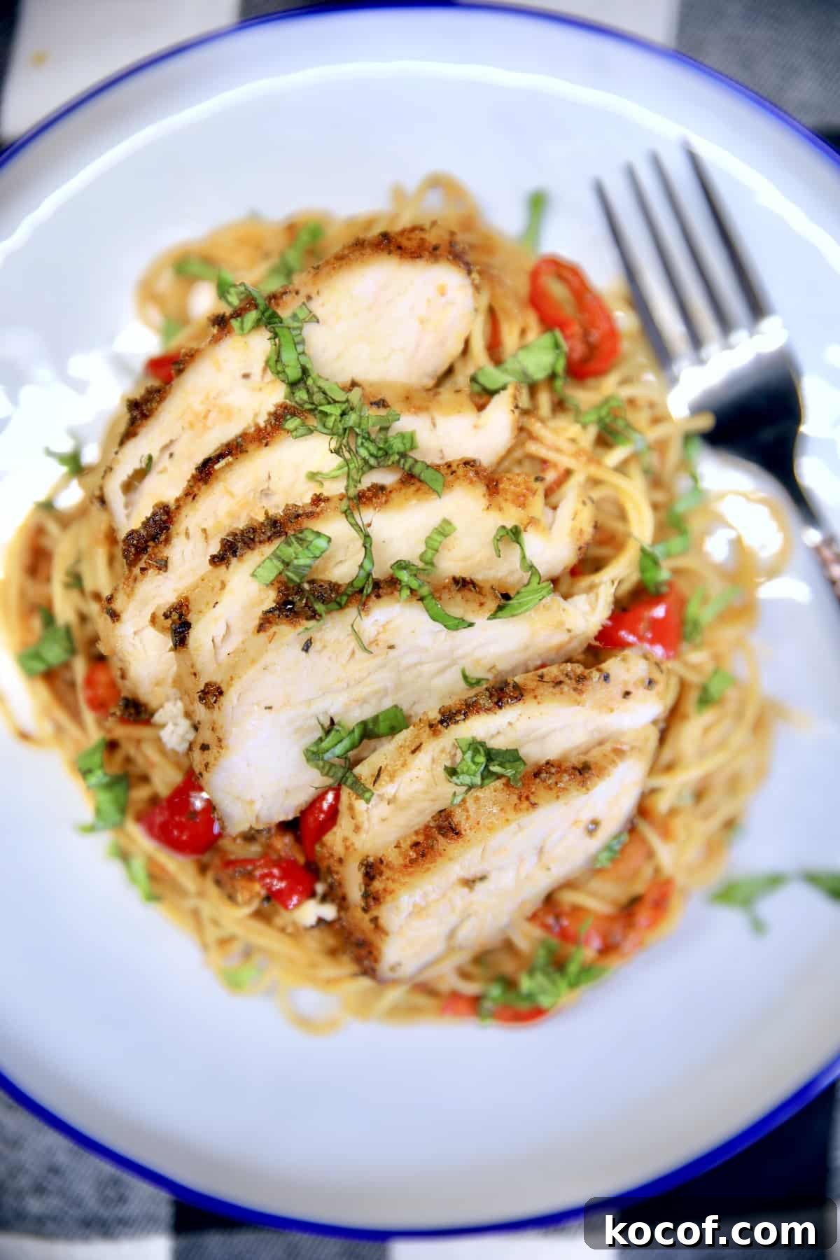 Spaghetti with homemade red sauce and grilled chicken. Closeup of plate of chicken spaghetti.