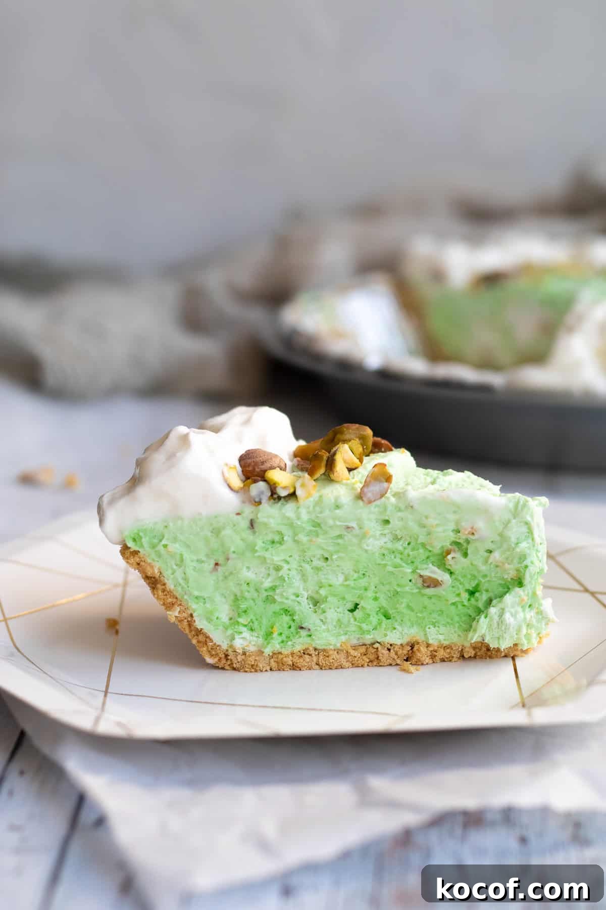 a slice of pistachio pie on a white plate