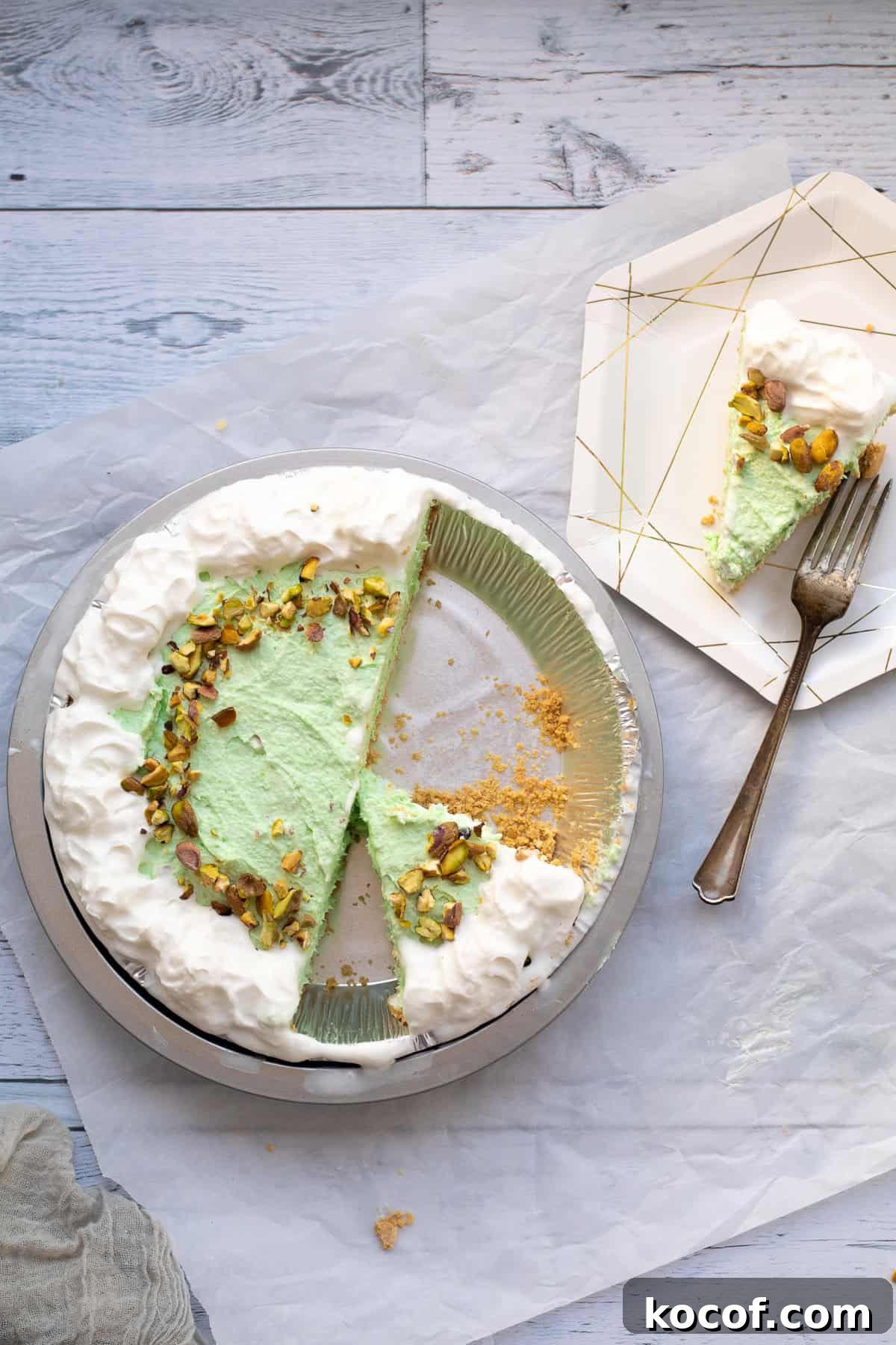 pistachio pudding pie that has been cut in it's pie tin