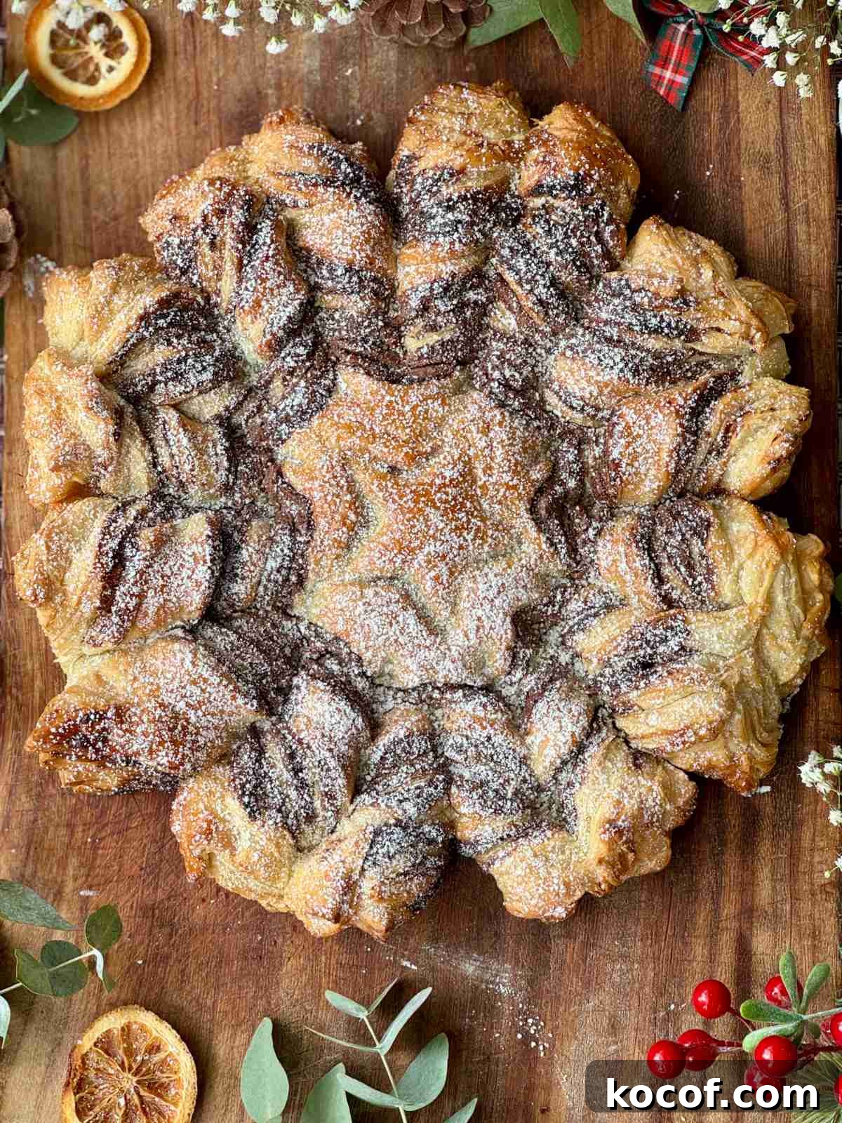 tarte soleil on a board with icing sugar.