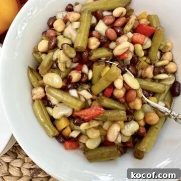 A spoon dishing up serving of bean salad.