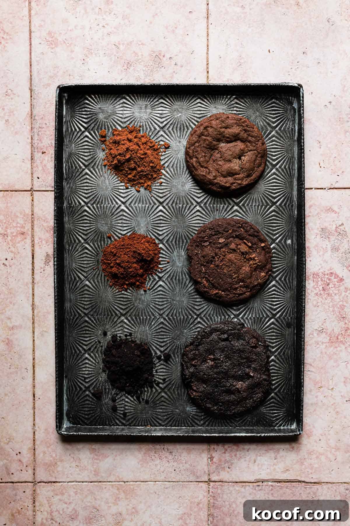 Three chocolate cookies, each baked with a different type of cocoa powder