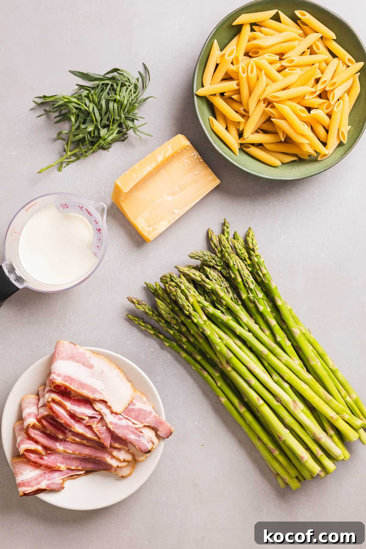 Creamy Bacon and Asparagus Pasta Recipe for Spring Meals 3 Ingredients for bacon and asparagus pasta on a gray table.