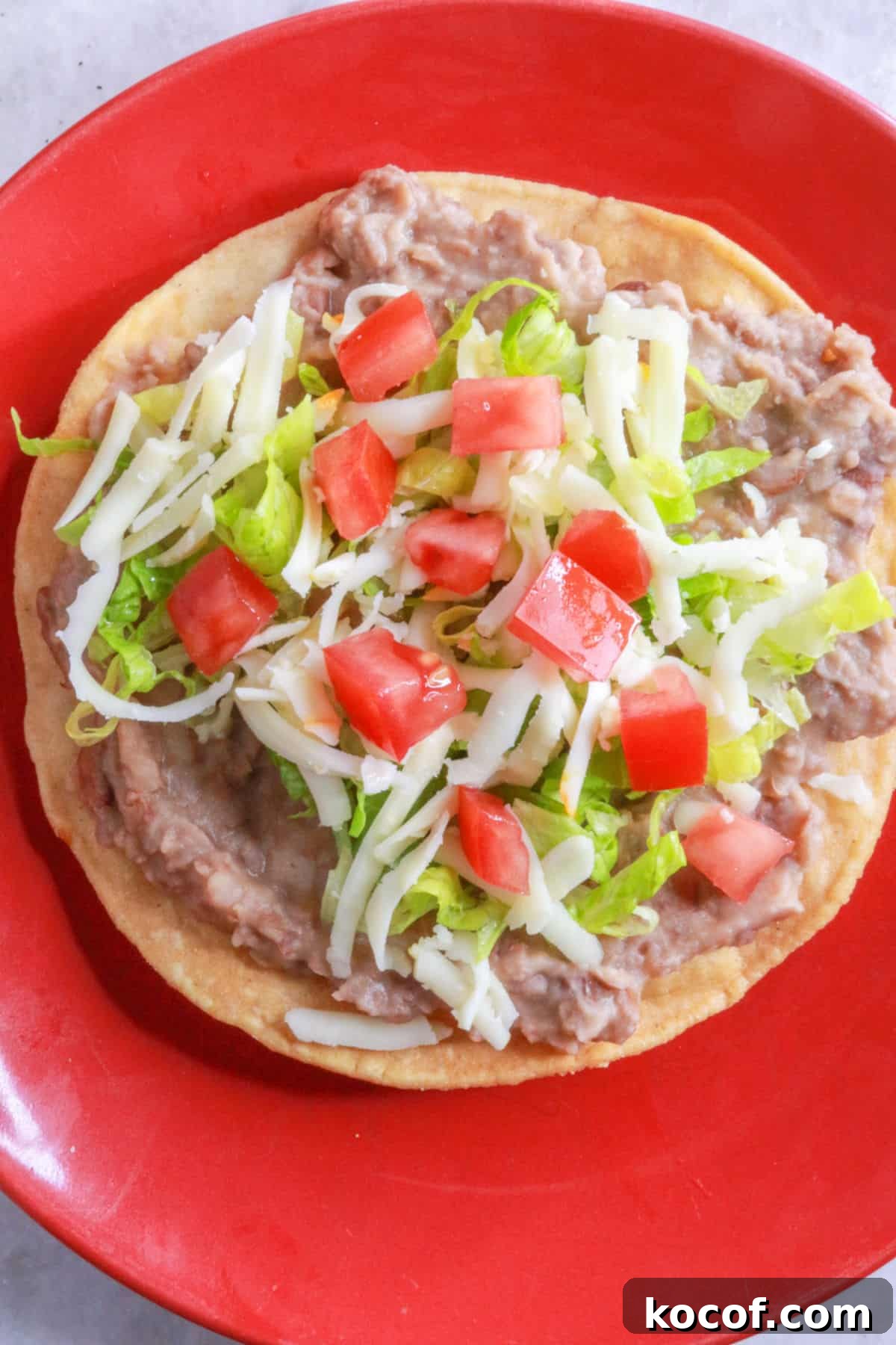 Refried Bean Tostadas with Crispy Tortillas and Fresh Salsa 8 Bean tostada with cheese, lettuce, and tomato