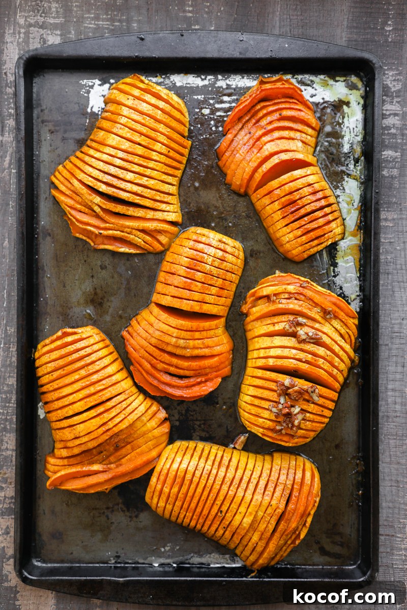 Hasselback squash on a baking pan pulled straight from the oven
