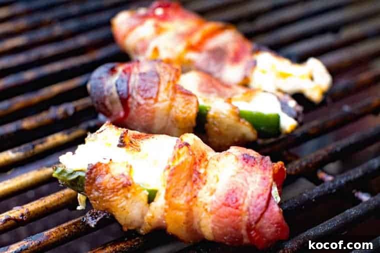 Bacon-Wrapped Jalapeño Poppers: Baked or Grilled Recipes 3 Grill rack with bacon wrapped jalapeno poppers on it