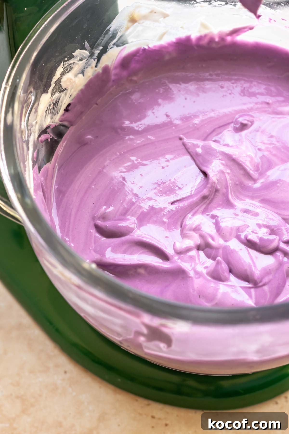 Creamy Ube Cheesecake Recipe: Filipino Purple Yam Dessert 11 Purple use cheesecake batter in a stand mixer bowl.