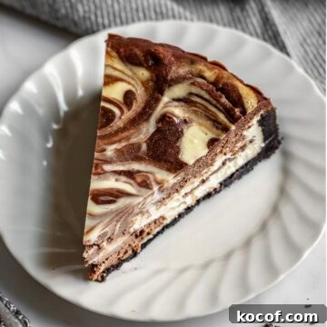 Slice of chocolate marble cheesecake on a plate.