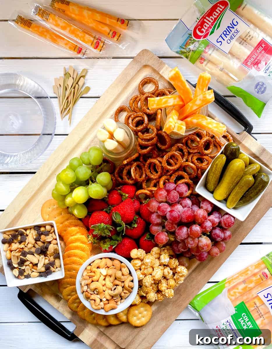 Kids snack board with cheese, fruit, snacks and nuts.
