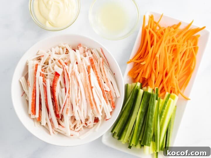 Crunchy Kani Salad Recipe with Crab Sticks and Fresh Veggies 14 Shredded crab stick next to julienned carrots and cucumber.