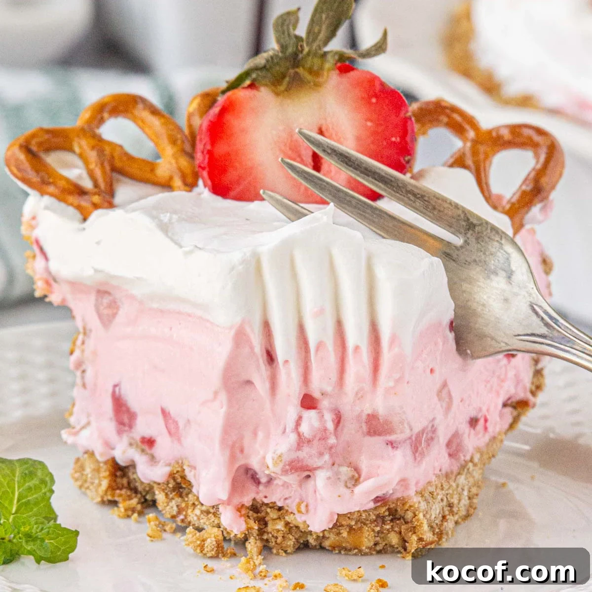 Classic Summer Strawberry Dessert Recipes You’ll Love 11 A slice of strawberry icebox pie being cut with a fork.