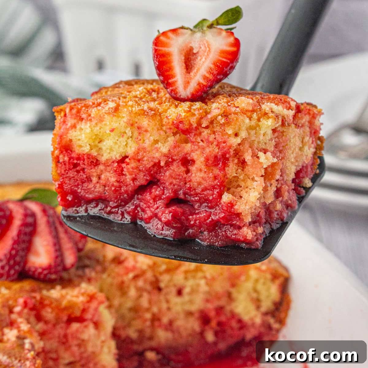 Classic Summer Strawberry Dessert Recipes You’ll Love 3 A square of strawberry shortcut cake being served from a spatula.