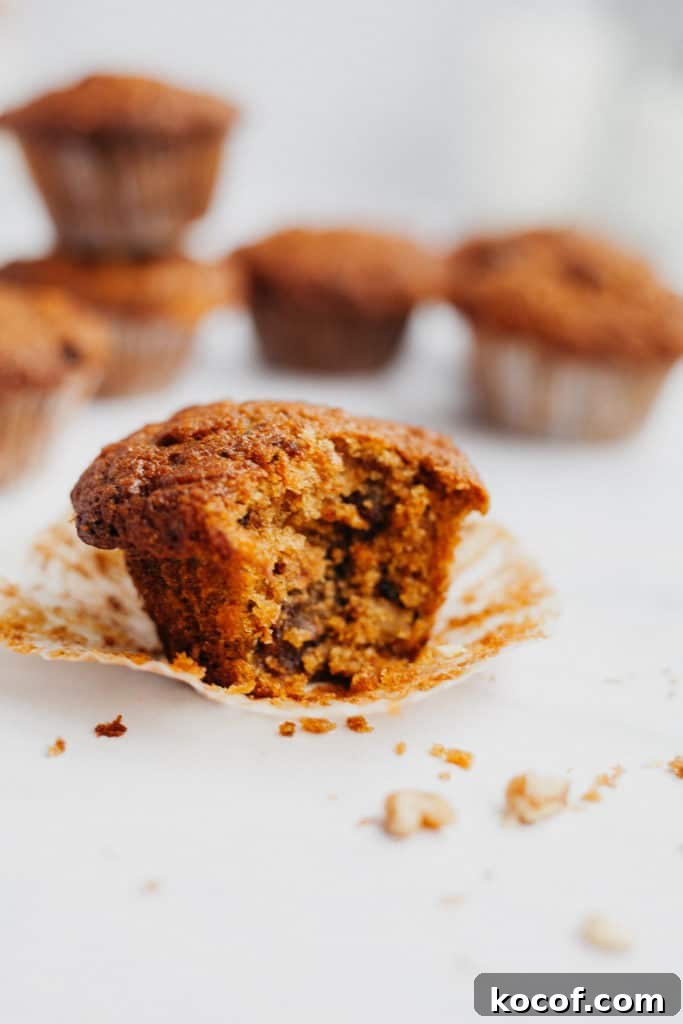 an apple and carrot muffin with a bite taken out of it