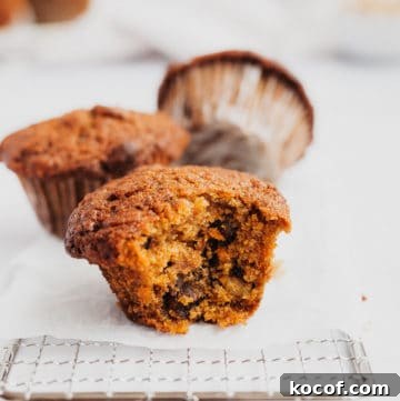 a muffin with a bite taken out of it on a small cooling rack
