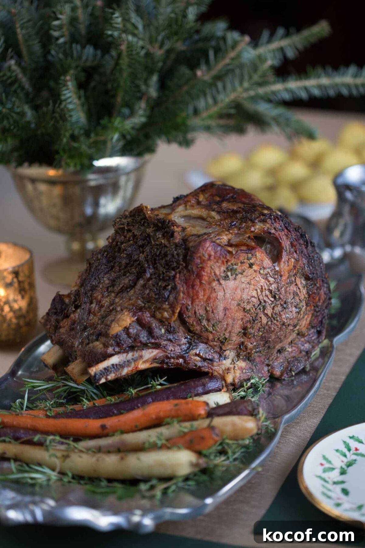 Herb-Roasted Prime Rib Roast: Tender, Juicy Holiday Recipe 2 herb prime rib on a metal platter with roasted carrots.