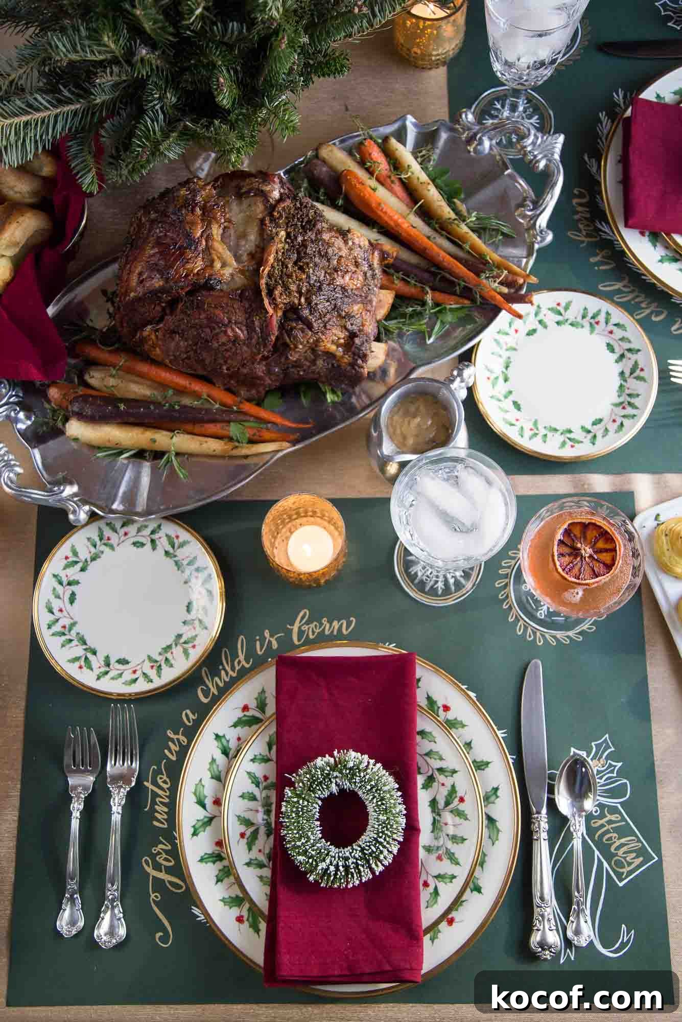 Herb-Roasted Prime Rib Roast: Tender, Juicy Holiday Recipe 6 table set for christmas dinner with china, a red napkin, and a prime rib.