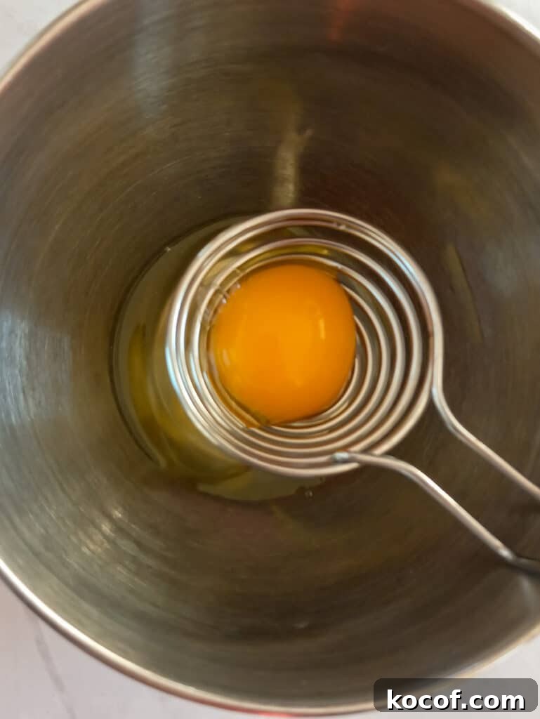 separating the eggs into a bowl.
