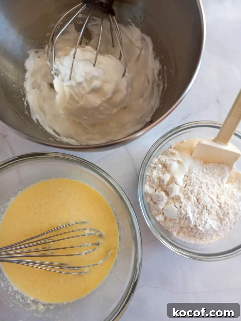 a bowl with beaten egg whites, another bowl with dry ingredients, and a third bowl with wet ingredients.