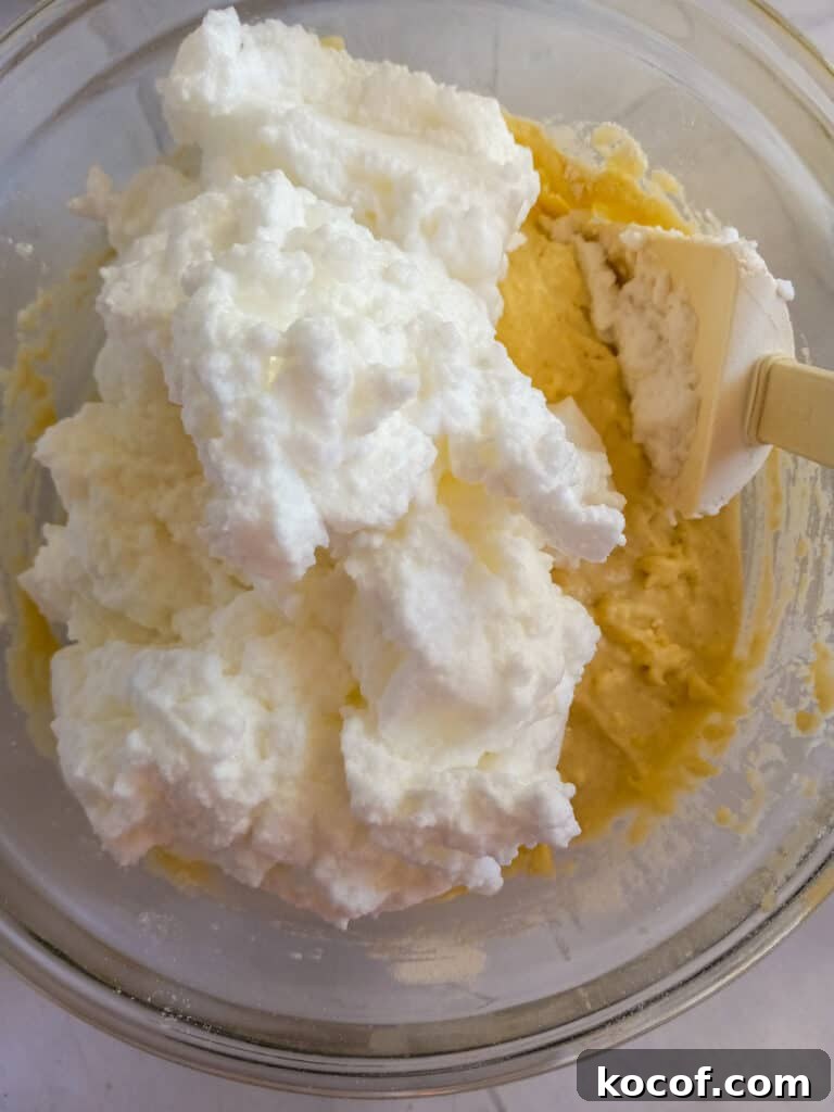 folding egg whites into the batter.