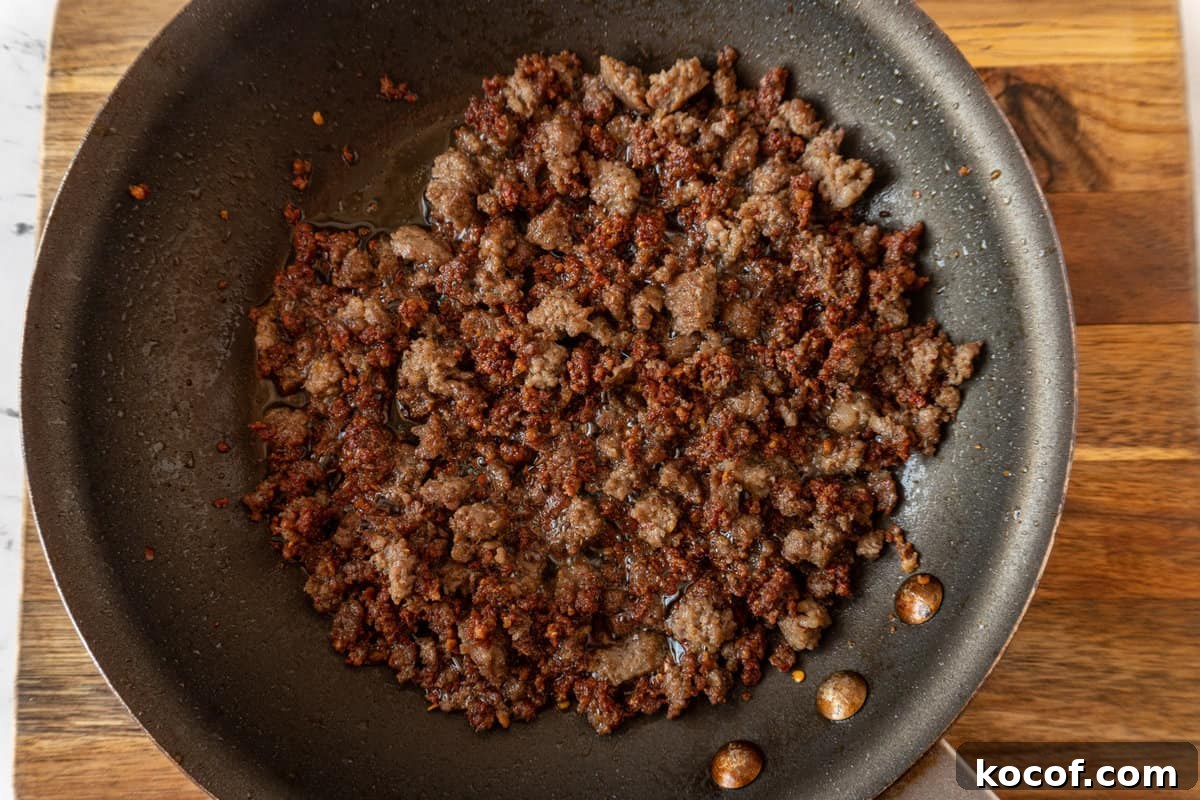 cooked sausage in nonstick pan.