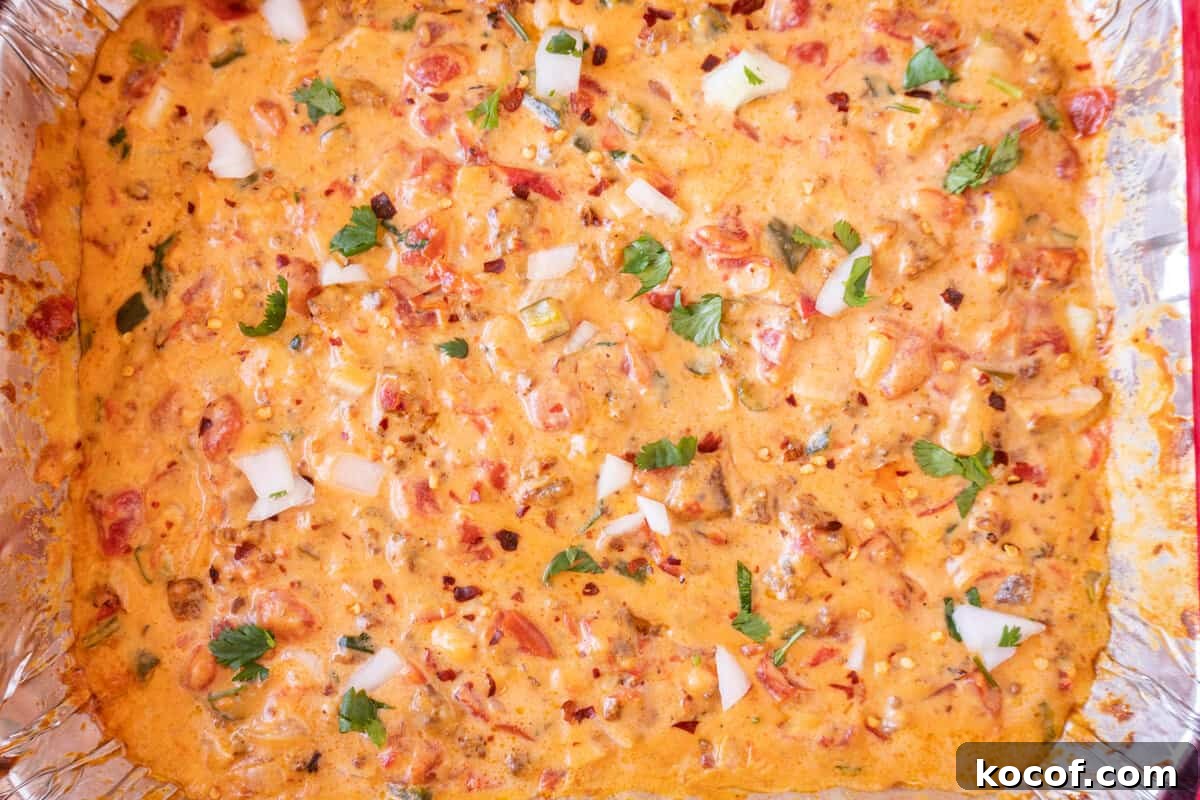smoked queso in an aluminum pan thinned with milk.