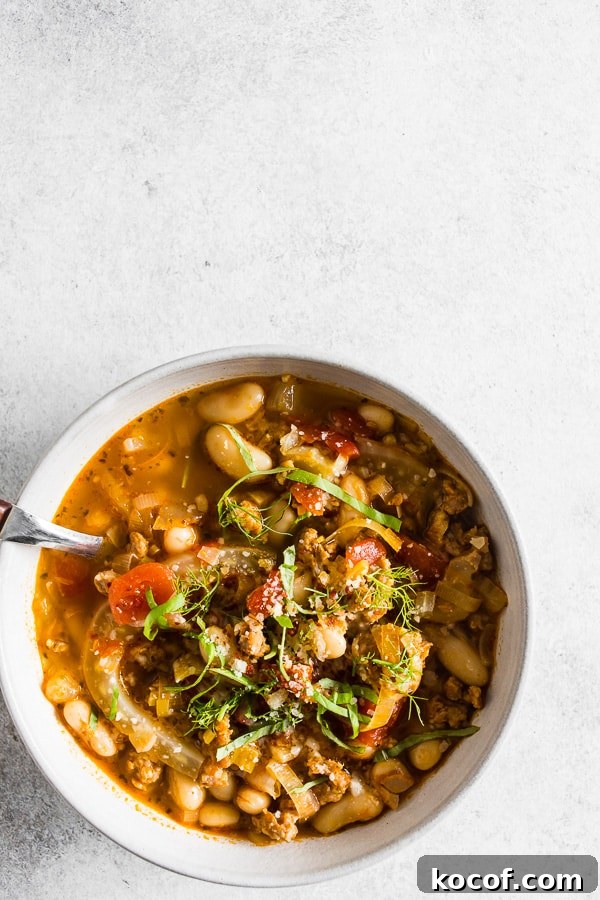Hearty Italian Sausage, Fennel & White Bean Soup Recipe 4 Italian Sausage Fennel White Bean Soup in a white bowl.
