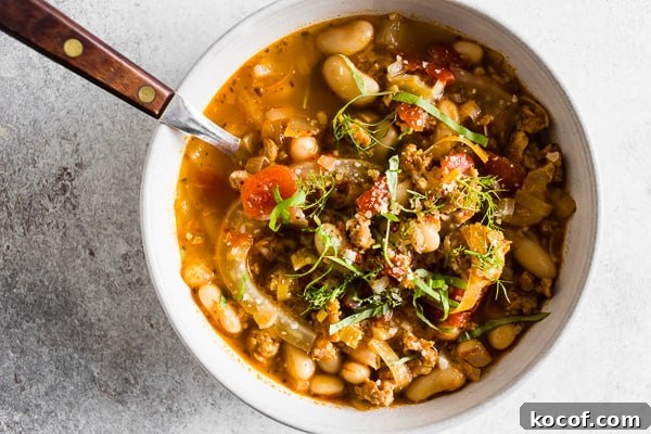 Hearty Italian Sausage, Fennel & White Bean Soup Recipe 6 Italian Sausage Fennel White Bean Soup topped with parmesan cheese.