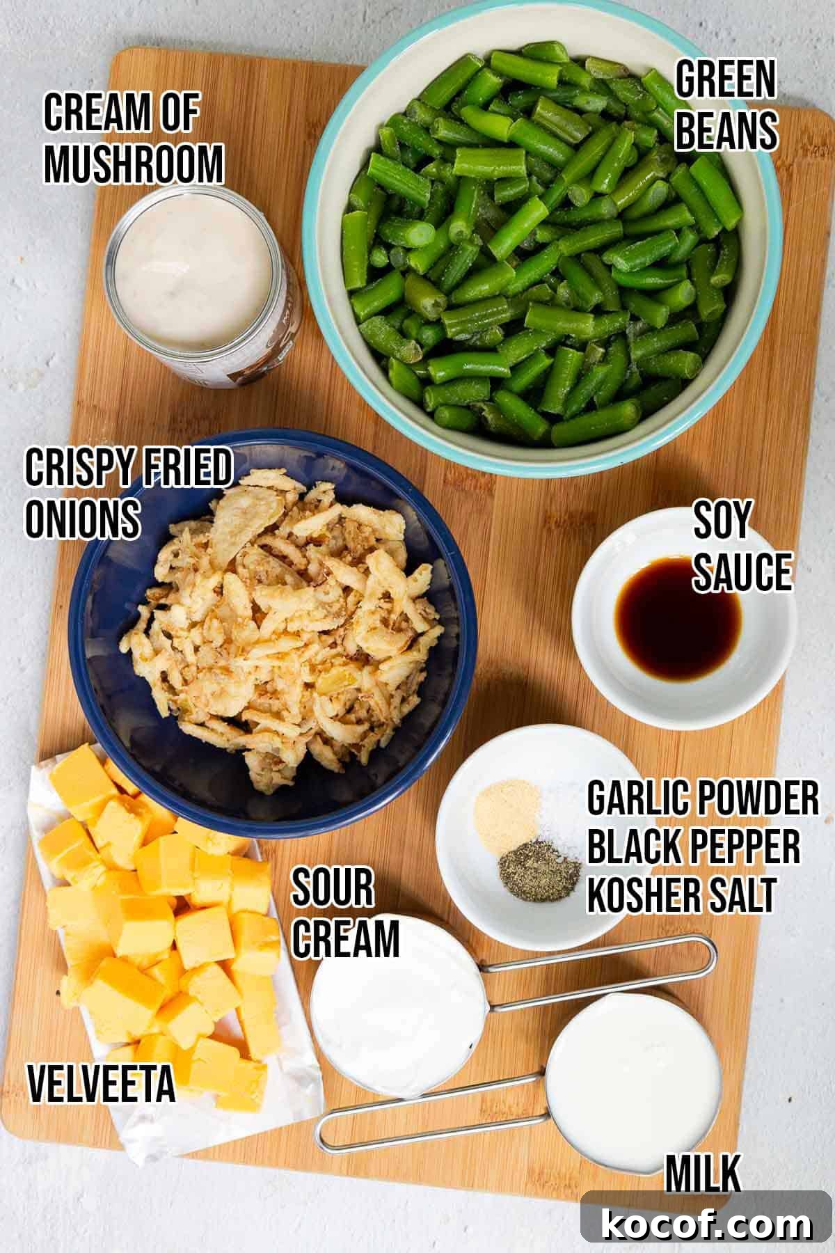 Velveeta Green Bean Casserole Recipe: Creamy, Cheesy Holiday Side 3 Velveeta green bean casserole ingredients include cream of mushroom soup, milk, Velveeta, green beans, crispy fried onions, sour cream, soy sauce, garlic powder, black pepper, and salt.
