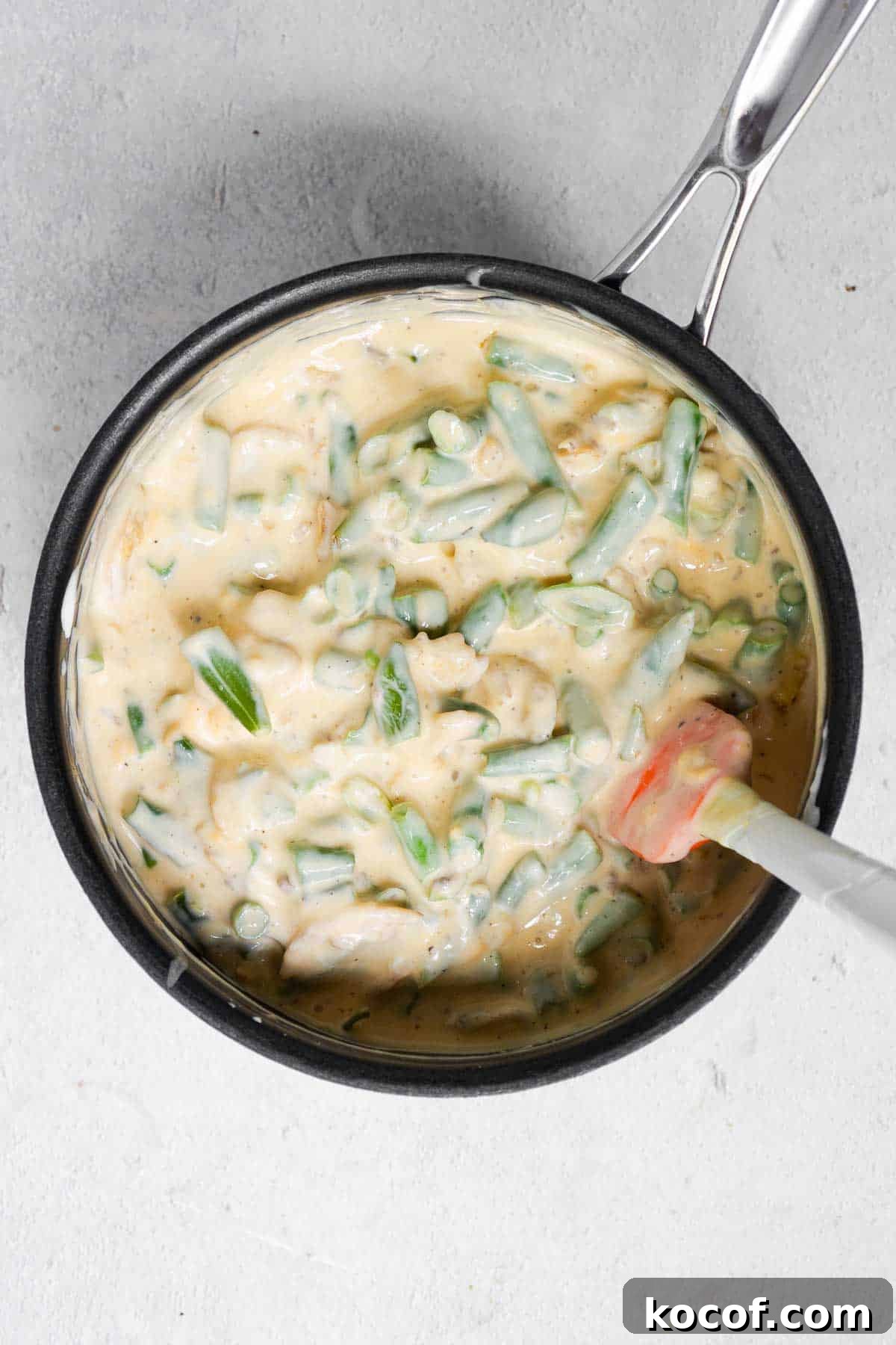 Velveeta Green Bean Casserole Recipe: Creamy, Cheesy Holiday Side 5 The green bean ingredients are added to the cheese and soup mixture and stirred until combined.