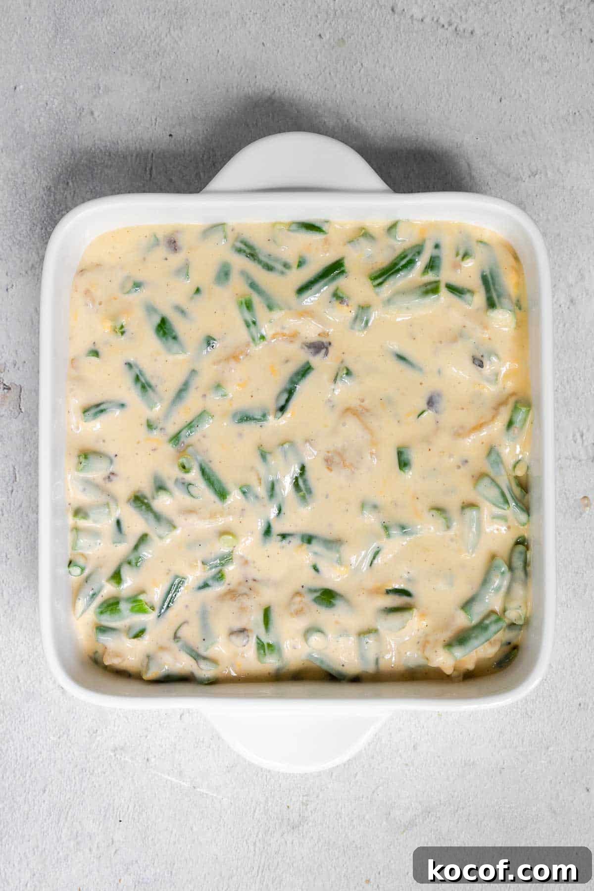 Velveeta Green Bean Casserole Recipe: Creamy, Cheesy Holiday Side 6 The green bean mixture is mixed and evenly spread in the 8 by 8 inch casserole dish.