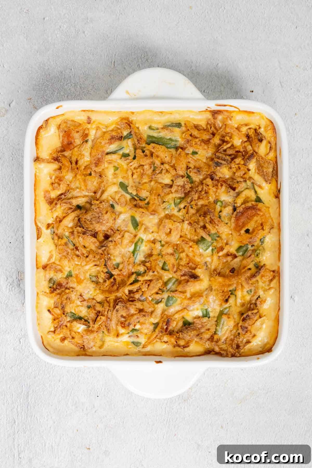 Velveeta Green Bean Casserole Recipe: Creamy, Cheesy Holiday Side 9 The crispy fried onions are baked until golden brown.