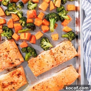 Salmon and vegetables on a baking sheet.