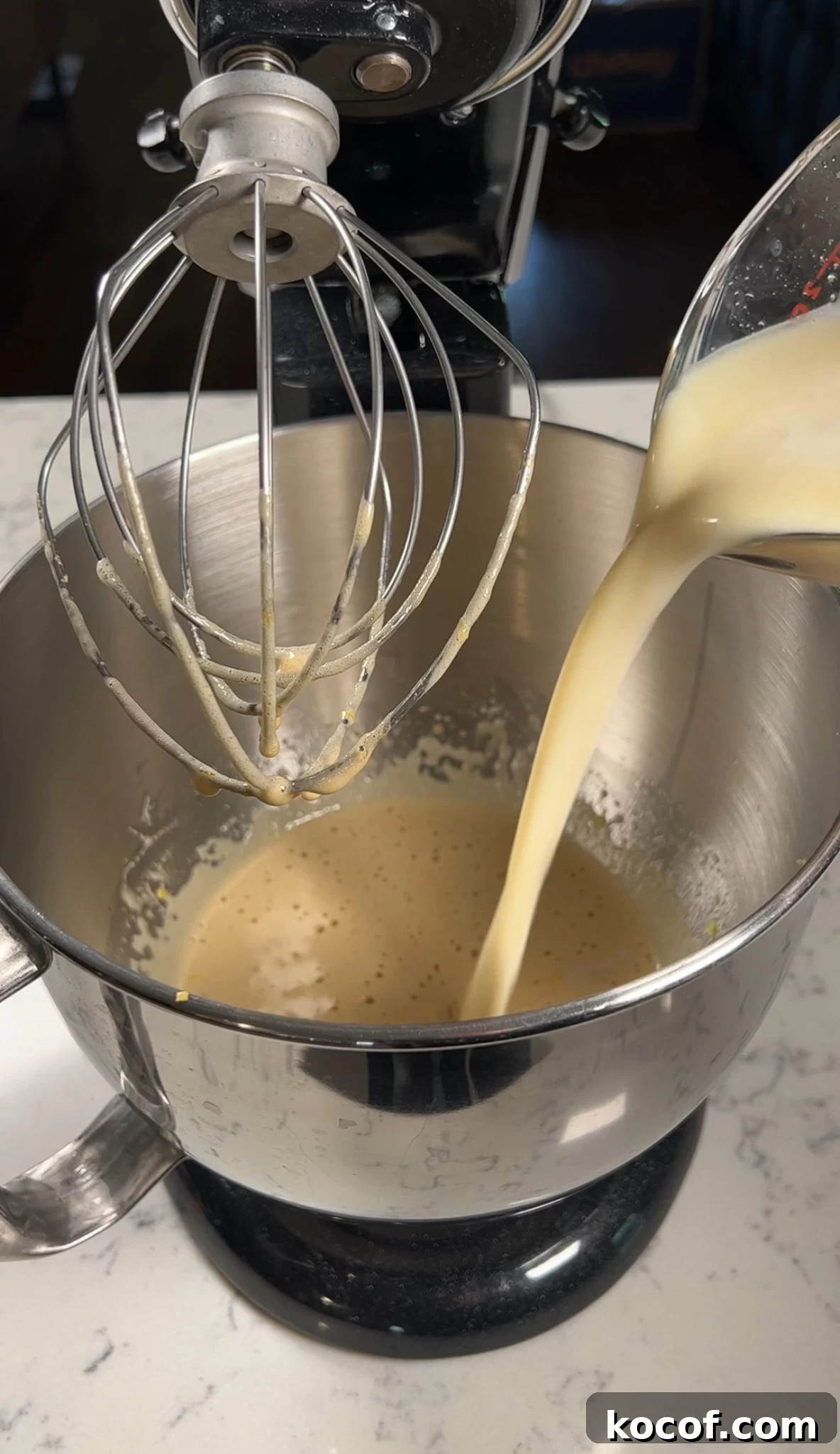Adding wet ingredients to the cake batter.