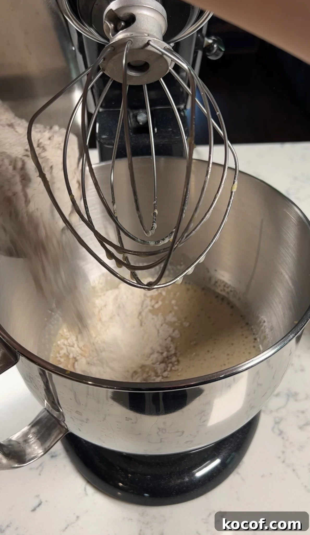 Adding dry ingredients to the cake batter.