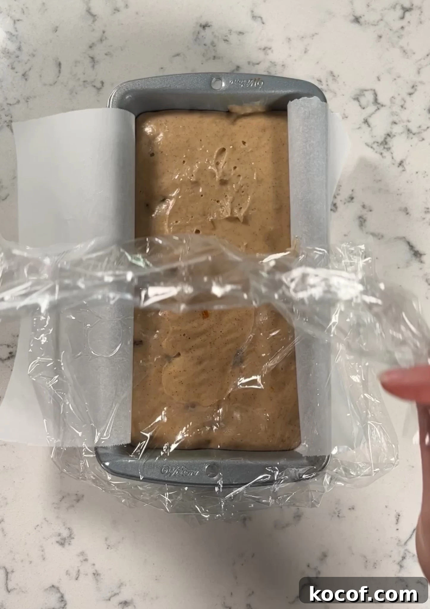 Uncovering the cake after rising.
