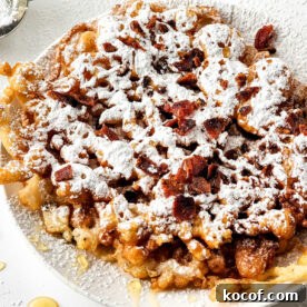 A delightful plate of funnel cake, dusted with powdered sugar and sprinkled with crunchy bacon bits, offers a heavenly taste experience. Perfect for those curious about how to make a funnel cake masterpiece.