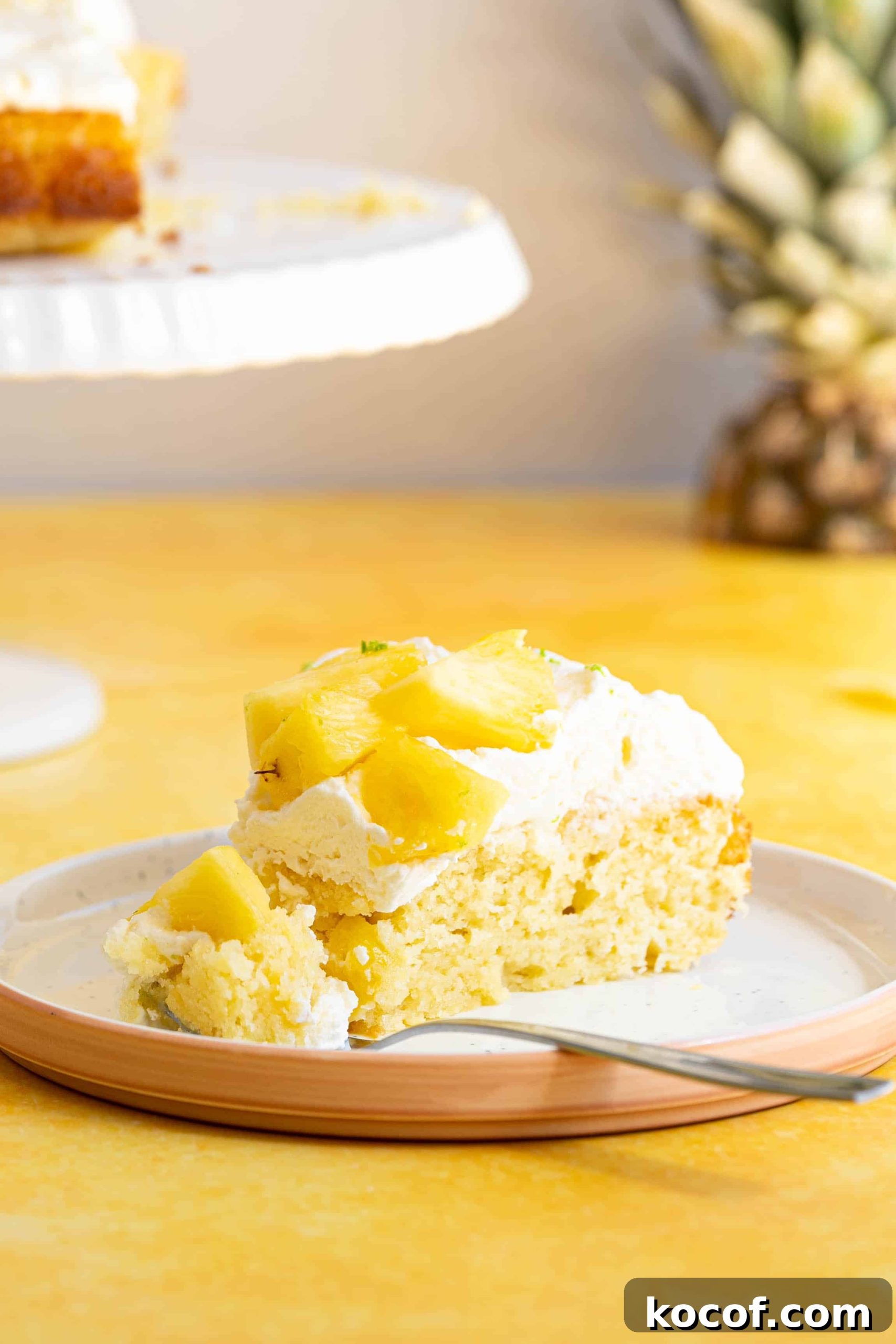 Moist Piña Colada Cake with Fresh Pineapple and Coconut 2 A slice of pina colada cake.