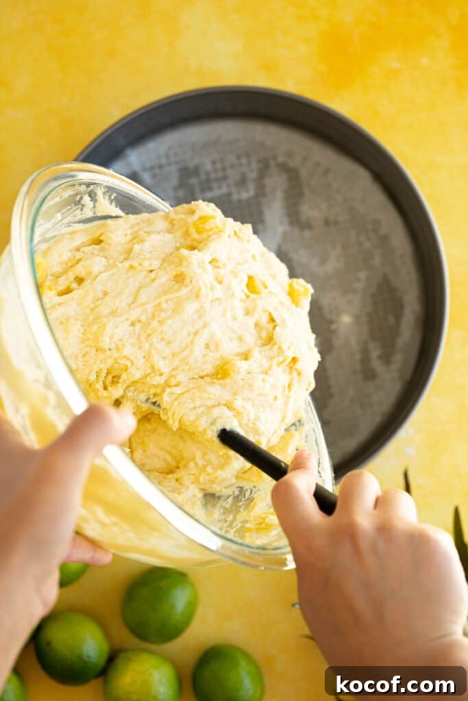 Moist Piña Colada Cake with Fresh Pineapple and Coconut 7 pina colada cake batter pouring into a pan