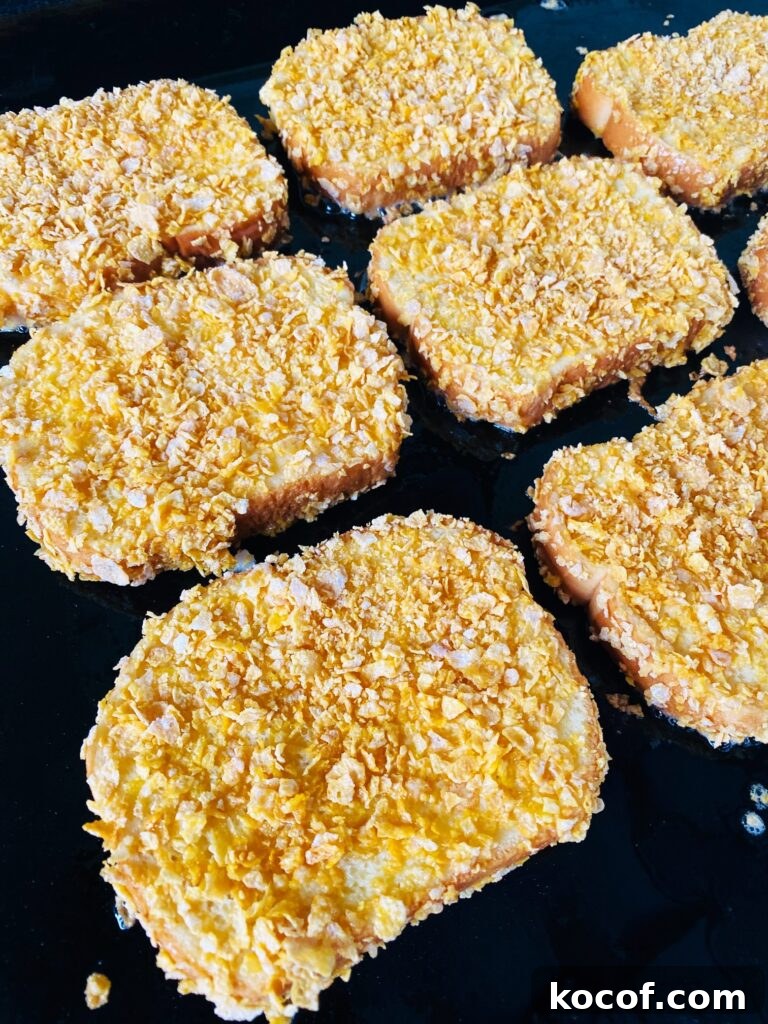 Blackstone Frosted Flake French Toast Recipe — Crispy Sweet Skillet Breakfast 6 french toast on the griddle before flipping