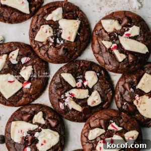 Just baked peppermint bark brownie crinkle cookies on a parchment paper lined baking sheet.