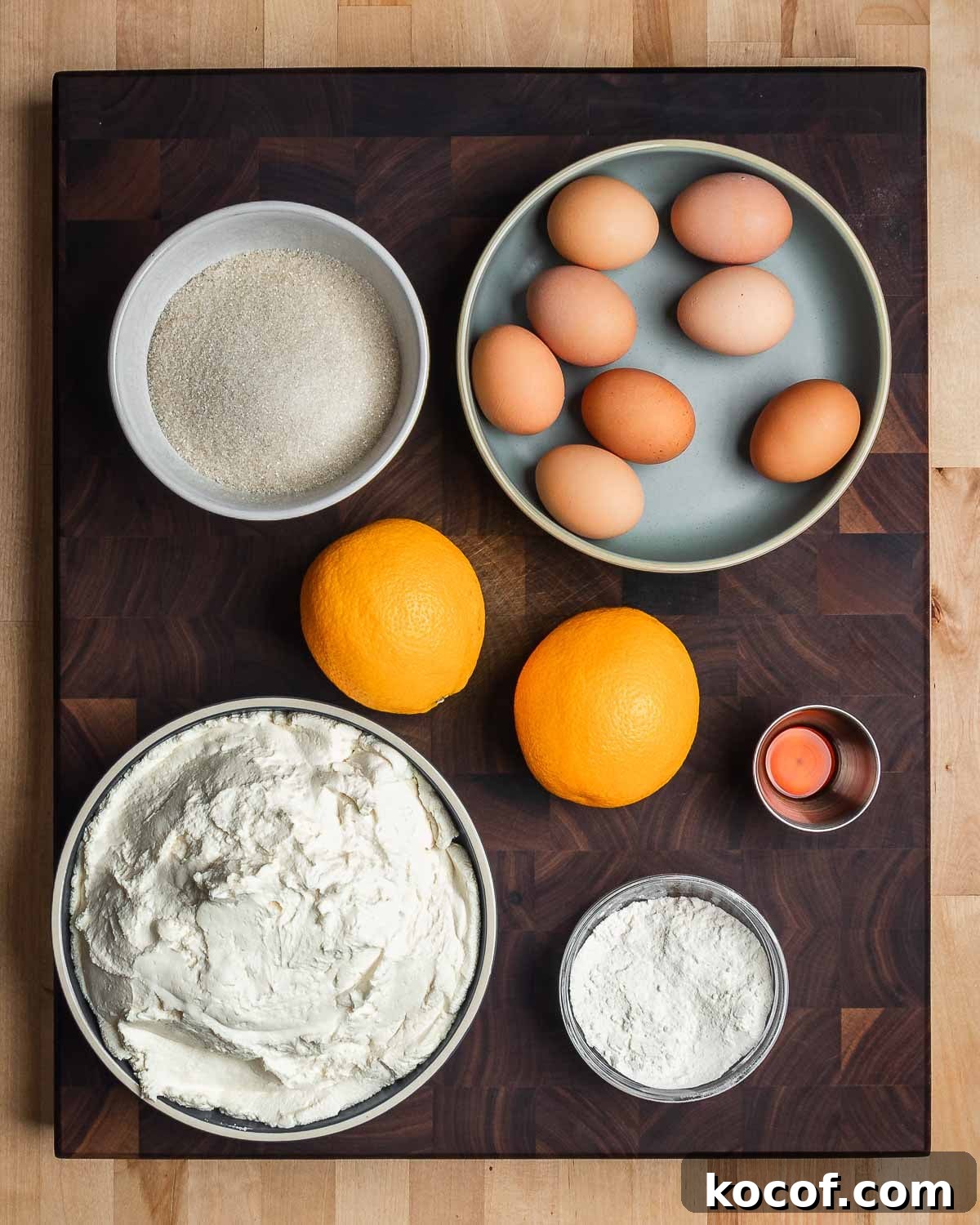 Authentic Italian Cheesecake Recipe: Classic Torta della Nonna Style 3 Ingredients shown: sugar, eggs, oranges, vanilla, ricotta, and flour.