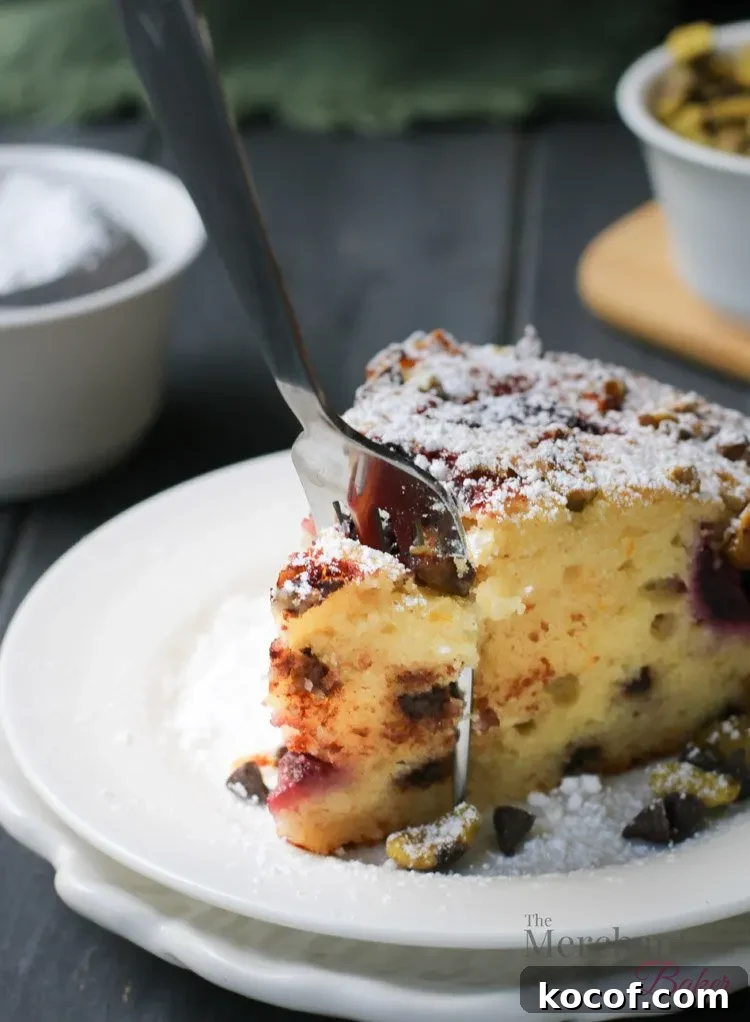 Cannoli-Inspired Breakfast Cake with Ricotta and Chocolate Chips 8 Sticking a fork into a slice of Easy Cannoli Breakfast Cake by The Merchant Baker