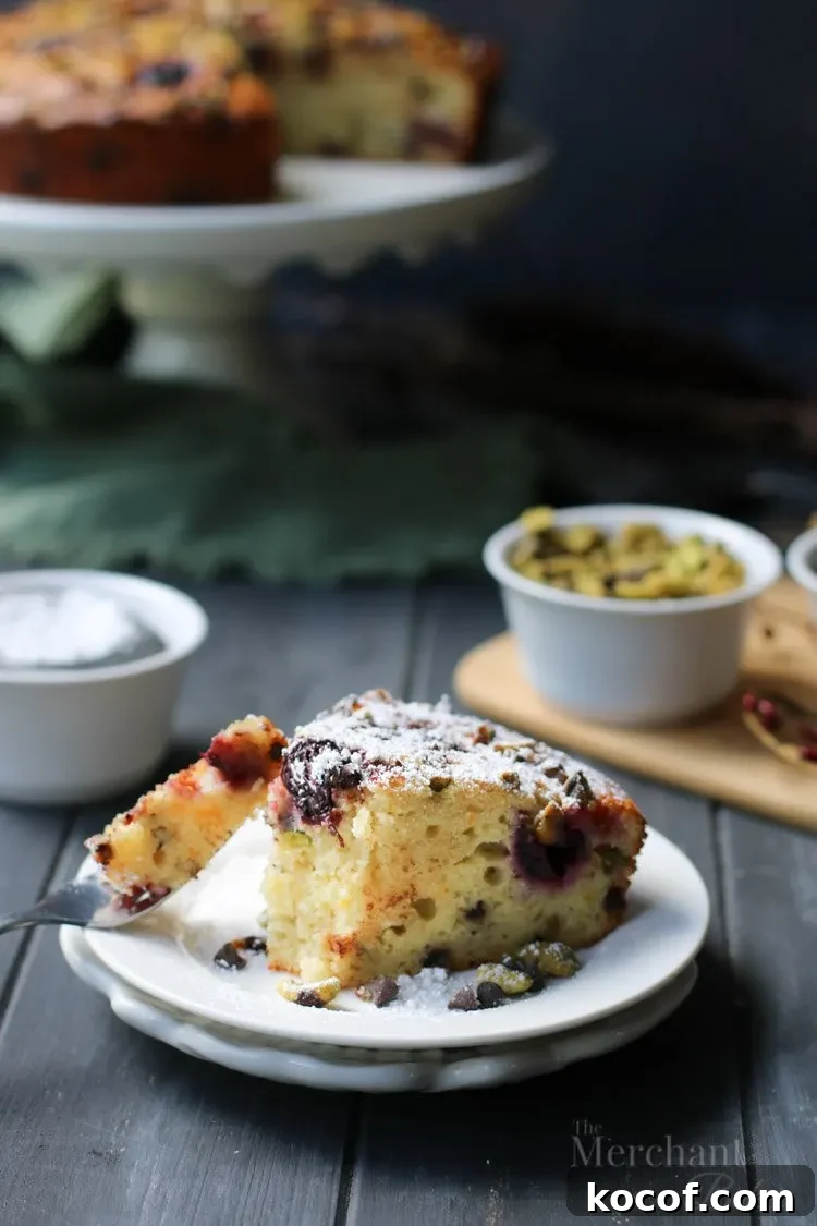 Cannoli-Inspired Breakfast Cake with Ricotta and Chocolate Chips 9 Slice of Easy Cannoli Breakfast Cake with a bite on a fork by The Merchant Baker