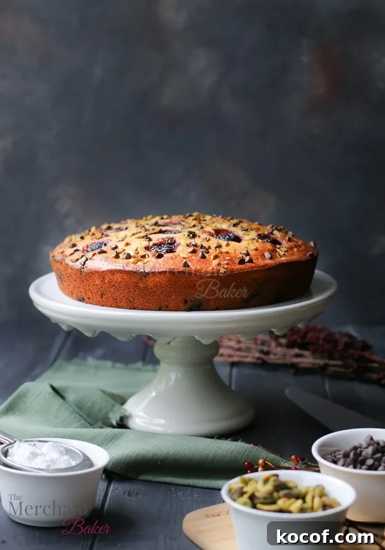 Cannoli-Inspired Breakfast Cake with Ricotta and Chocolate Chips 4 Side view of Easy Cannoli Breakfast Cake on a cake stand by The Merchant Baker