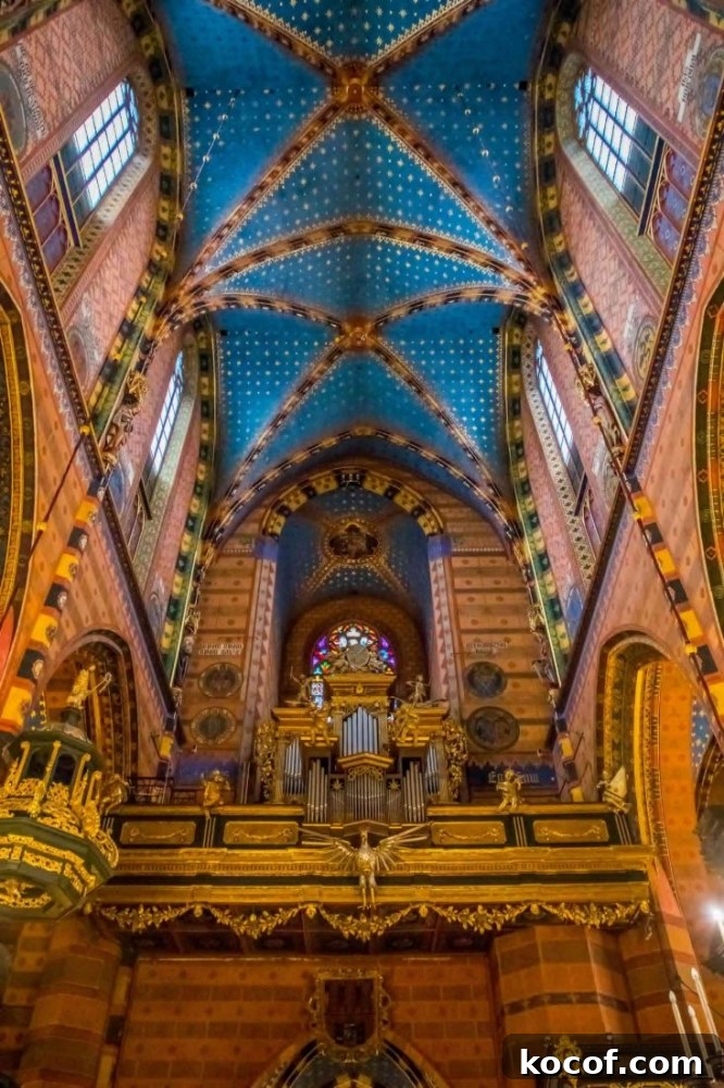 The inside of Saint Mary's Basilica in Krakow, Poland featuring an ornate ceiling.