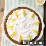 Lemon Cream Pie with Graham Cracker Crust Recipe 4 Overhead view of a lemon cream pie with whipped cream topping.